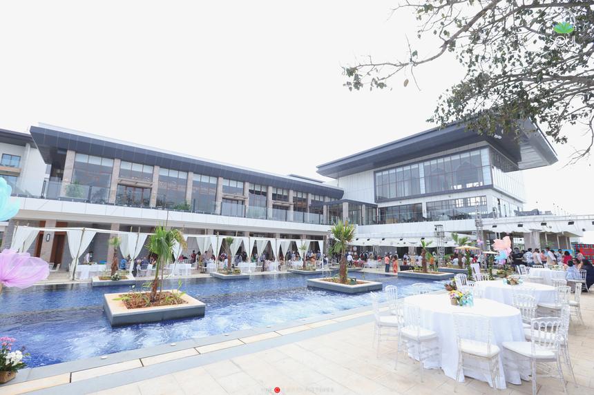 The poolside brunch set with round tables and white chairs
