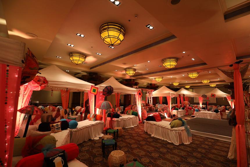 The mehendi hall in warm red drapery and lanterns
