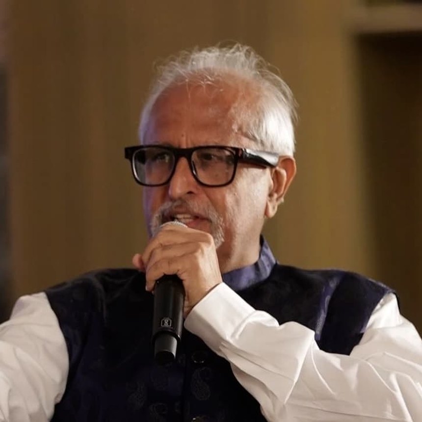 Ramesh Sadhwani speaking into a microphone on stage