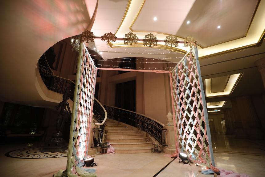 A mirrored staircase entrance dressed for the reception