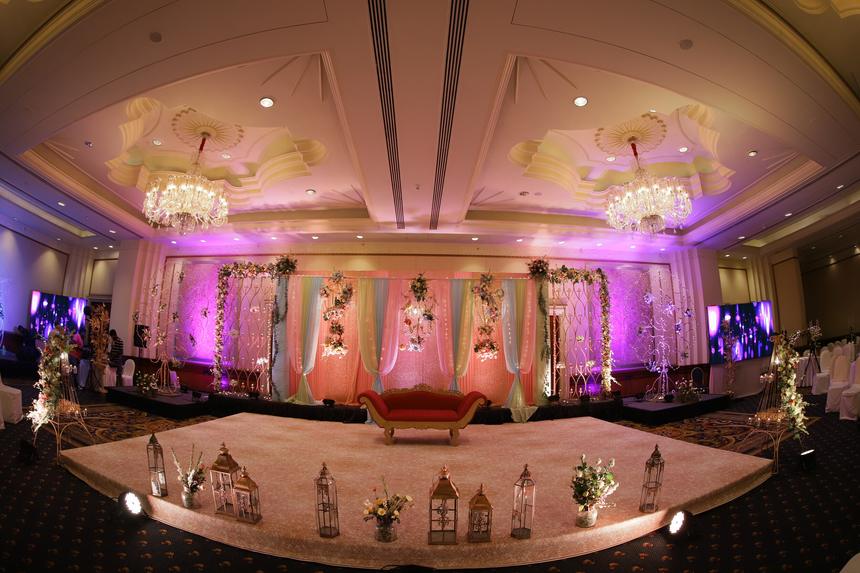 A full ballroom stage lit for the evening, seen from the floor